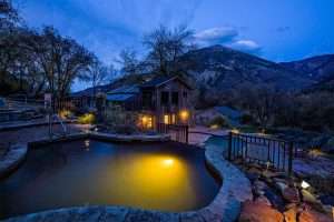 Hot springs pool evening lights at colorado women's nature retreat