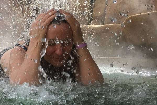 woman enjoying hot springs waterfall at colorado women's nature retreat