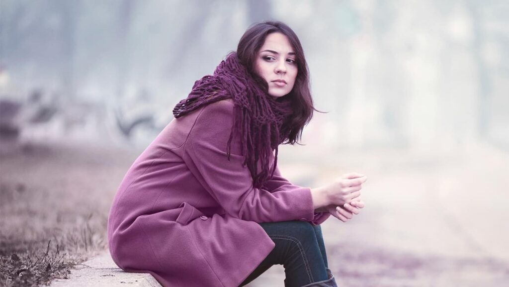 woman in purple coat feeling disappointment of self-betrayal